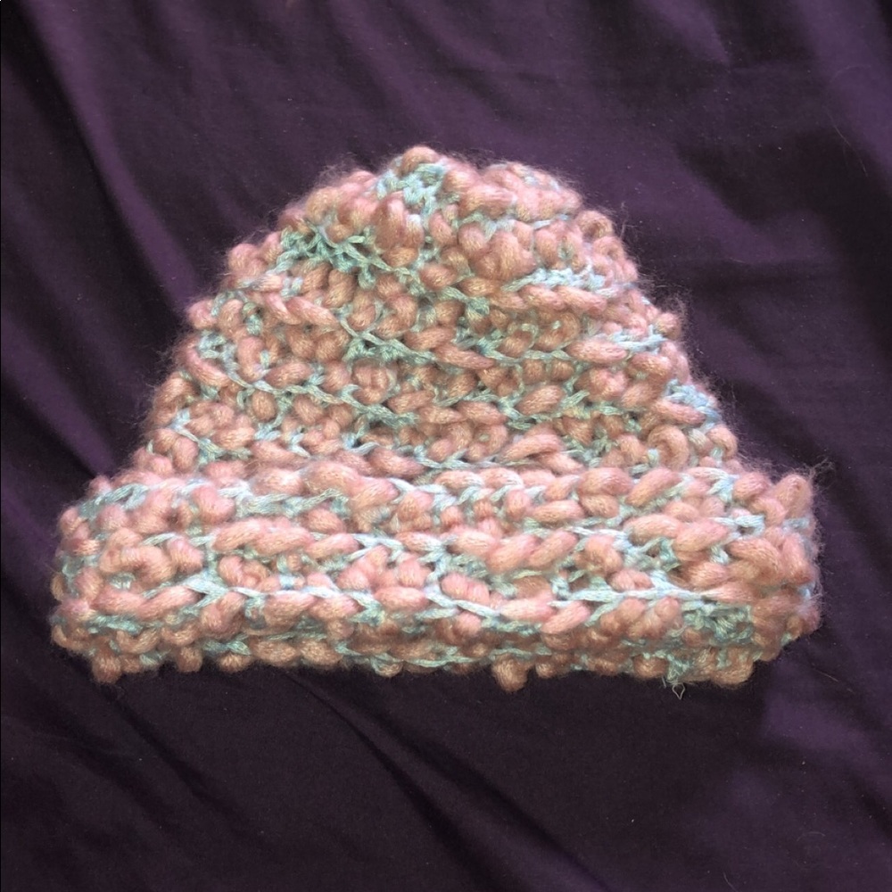 Hand crocheted pink and blue yarn winter hat.